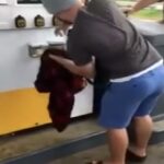 He bends over to grab the gas pump – but what comes out will make you scream